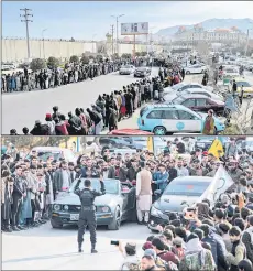  ?? ?? Afghan motorsport enthusiast­s watching drivers ride modified cars as they compete in a drag race during a car racing event in Kabul.