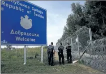  ?? DARKO VOJINOVIC/ASSOCIATED PRESS ?? Hungarian police officers guard the border at the Horgos border crossing into Hungary, near Horgos, Serbia, on Tuesday.
