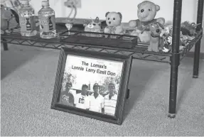  ?? ?? Larry Lomax has a photo of him and his brothers in his home. He was going to visit his younger brother when police attacked him and falsely charged him with heroin possession.