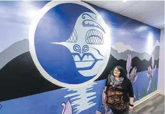  ?? DARREN STONE, TIMES COLONIST ?? Songhees artist Brianna Dick with the mural titled Camas Dreams that she painted in one of the Moksana Yoga studios at 613 Pandora Ave.