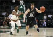  ?? LYNNE SLADKY — THE ASSOCIATED PRESS ?? North Florida’s Ivan Gandia-Rosa (21) drives to the basket as Miami’s Chris Lykes (2) defends during the first half of an NCAA college basketball game, Saturday in Coral Gables, Fla.