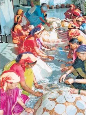  ??  ?? At Lijjat, members roll dough on special platforms for uniformly sized papads. The co-operative sells more than 4 billion papads a year.