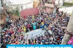  ?? —AFP ?? YAOUNDE: Cameroonia­n opposition leader Maurice Kamto is greeted and acclaimed by hundreds of supporters in Yaounde after his release from prison.