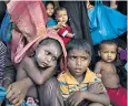  ??  ?? Rohingya children wait for a food handout in Kutupalong camp in Bangladesh