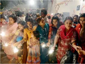  ?? AFP ?? THE REAL STARS... Diwali means, in addition to lights and crackers, sparkling women who make a splash. —