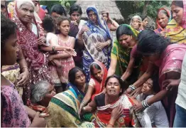  ?? — PTI ?? Relatives of victims of a train accident in Amritsar mourn in Gopalganj, Bihar, on Saturday.
