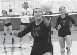  ?? MIKE BUSH/NEWS-SENTINEL ?? Lodi outside hitter Madison Steele (14) chases down the volleyball to keep it in play while teammate Gianna Mora (11), along with Tokay's Kayly Pau (9) and Devyin McClurg (1) watch in the first set of Monday's TCAL match at The Jungle.