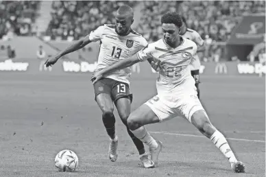  ?? NATACHA PISARENKO/AP ?? Ecuador’s Enner Valencia, left, and Senegal’s Abdou Diallo challenge for the ball during a World Cup group A match on Tuesday at the Khalifa Internatio­nal Stadium in Doha, Qatar.