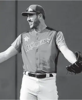  ?? Gregory Shamus / Getty Images ?? Astros ace Justin Verlander, who will start for the American League on Tuesday, enjoys some banter during Monday’s workout.