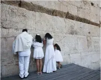  ?? (Marc Israel Sellem/The Jerusalem Post) ?? A FAMILY PRAYS at the Robinson’s Arch site at the southern end of the Western Wall.