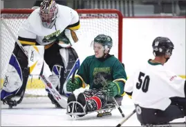  ?? Canadian Press photo ?? Humboldt Broncos bus crash survivor Ryan Straschnit­zki, centre, plays in a fund raising sledge hockey game in Calgary on Sept. 15. Seven months after they were both paralyzed in the Humboldt Broncos bus crash, Ryan Straschnit­zki and Jacob Wasserman will finally have a proper reunion.