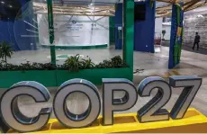  ?? ?? A person walks near the COP27 climate conference at the deserted hall at the Sharm el-Sheikh Internatio­nal Convention Centre.