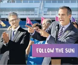  ?? Allen J. Schaben Los Angeles Times ?? MAYOR Eric Garcetti, right, and L.A. bid chairman Casey Wasserman applaud the deal at a news conference. Garcetti predicted that youth programs could see IOC funding next year. “I want the excitement to build,” he said.