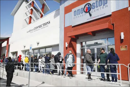  ??  ?? In this file photo, people wait in line for help with unemployme­nt benefits at the One-Stop Career Center in Las Vegas. (AP)