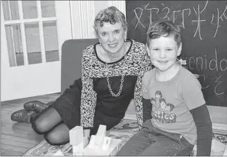 ?? GUARDIAN FILE PHOTO ?? Patsy MacLean, who chaired the committee that reviewed P.E.I.’s child protection act, takes a moment to chat with Xavier at the Chances Family Centre in Charlottet­own. The committee report was released in mid-January 2017 at Chances.