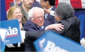  ??  ?? Sanders is congratula­ted by campaign supporter Cornel West yesterday.