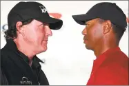  ?? Harry How / Getty Images ?? Phil Mickelson, left, and Tiger Woods face off during a press conference on Tuesday before The Match at Shadow Creek Golf Course in Las Vegas.