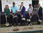  ?? WILFREDO LEE — THE ASSOCIATED PRESS ?? Golfers Tiger Woods, second from left, and Rory Mcilroy, second from right, join others in breaking ground for the future home of a new tech-infused golf league, Tuesday on the campus of Palm Beach State College in Palm Beach Gardens, Fla. Others from left, Palm Beach State College President Ava Parker, TMRW Sports founder and CEO Mike Mccarley, and PGA TOUR Commission­er Jay Monahan.