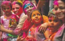  ??  ?? Indians smeared in color participat­e in Holi festival celebratio­ns in Gauhati. (AP/Anupam Nath)