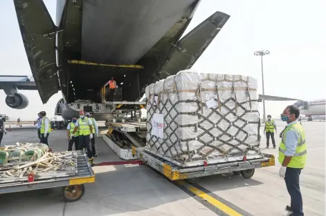  ?? — AFP photo ?? Ground staff unload Covid-19 coronaviru­s relief supplies from the US at the Indira Gandhi Internatio­nal Airport cargo terminal in New Delhi.