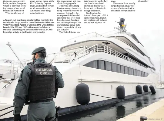  ?? FRANCISCO UBILLA AP ?? A Spanish civil guardsman stands vigil last month by the seized yacht Tango, which is owned by Russian billionair­e Viktor Vekselberg. Agents of Spain and the United States boarded the 255-foot, $90 million vessel in Palma de Mallorca. Vekselberg was sanctioned by the U.S. in 2018 for malign activity in the Russian energy sector.