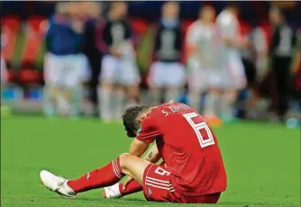  ?? SERGEI GRITS/THE ASSOCIATED PRESS ?? Iran’s Saeid Ezatolahi sits on the ground after the end of a Group B match between Iran and Spain Wednesday in the Kazan Arena in Kazan, Russia. Spain won the match 1-0.