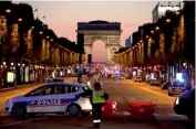  ?? — AFP ?? Police blocks the access to the Champs Elysees near the Arc de Triomphe in Paris after a shooting Thursday.