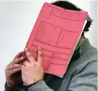  ??  ?? Killer: Hoegel hides his face behind a book in court in 2015