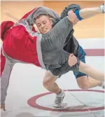  ?? KAZ NOVAK HAMILTON SPECTATOR FILE PHOTO ?? Jason Buckle works with his McMaster teamate and training partner Chris Garneau during a parctice session.