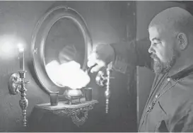 ?? Maria D. De Jesus / Houston Chronicle ?? Jacob No, founder of the Greater Church of Lucifer, lights a fire inside the church. Luciferian­s believe in the importance of self-liberation from restrictiv­e beliefs and the study of occult wisdom.