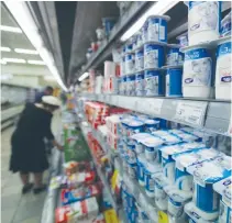  ?? (Marc Israel Sellem/The Jerusalem Post) ?? A SHOPPER at a Jerusalem supermarke­t recently peruses the wide variety of dairy products for sale.