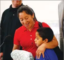  ?? AP PHOTO ?? Beata Mariana de Jesus Mejia-mejia embraces her son Darwin Micheal Mejia as she speaks at a news conference following their reunion at Baltimore-washington Internatio­nal Thurgood Marshall Airport on Friday.