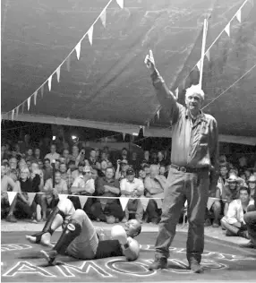  ??  ?? For Fred Brophy, shown here declaring the winner of a bout, having his own troupe is something of a family tradition. - AFP photo