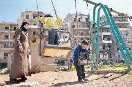  ?? Liliana Nieto del Rio For The Times ?? SYRIAN FAMILIES have begun returning to eastern Aleppo after years of occupation. Pieces of rock salvaged from the rubble serve as playground seats.