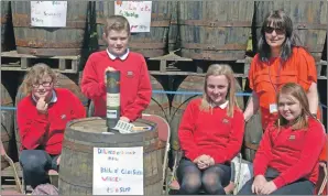  ?? 25_c22glensco­tia01 ?? Glen Scotia donated a limited edition bottle for Dalintober primary to raffle. With Claire MacPherson, the P7s running the stall were: Jamie-Leigh Allen, Brook Oxborrow, Dion Maguire and Liam McMillan.