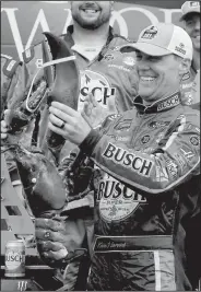  ?? AP/MARY SCHWALM ?? Kevin Harvick holds up a lobster after his victory Sunday in the NASCAR Monster Energy Cup race in Loudon, N.H. Harvick won his 43rd career race. It was the sixth time this season that Stewart-Haas Racing finished first. The race was delayed more than three hours by rain.