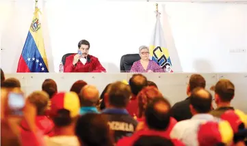  ?? — Reuters photo ?? Maduro (left) holds a copy of the Venezuelan constituti­on as he speaks next to Lucena during their meeting in Caracas, Venezuela.