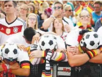  ?? ?? German supporters are dejected at the end of the match.