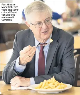  ??  ?? First Minister Mark Drakeford tucks into some chips at Page’s fish and chip restaurant in Cwmbran