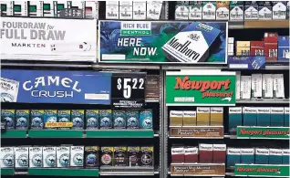  ??  ?? In this Friday, July 17, 2015 file photo, Camel and Newport cigarettes, both Reynolds American brands, are on display at a Smoker Friendly shop in Pittsburgh. British American Tobacco Plc has agreed to fully take over Reynolds American Inc on terms...