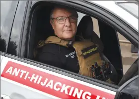  ?? ?? Anton Koen, a former police officer who now runs a private security firm that specialize­s in tracking and recovering hijacked and stolen vehicles, prepares to go out on patrol Nov. 28 east of Johannesbu­rg.