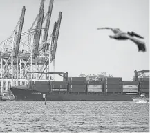  ?? Joe Raedle / Getty Images ?? A container ship docks in Miami. The U.S. economy grew at an annual rate of 2.3 percent in the first quarter.