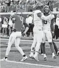  ?? [PHOTO BY NATE ?? TCU quarterbac­k Kenny Hill Jr., center, and teammate Darius Anderson celebrate a touchdown as Oklahoma State’s A.J. Green reacts in the Frogs’ 44-31 victory on Sept. 23.