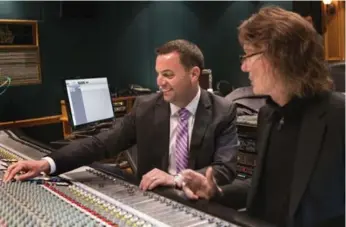  ?? CHRIS YOUNG/THE CANADIAN PRESS ?? Tory Leader Tim Hudak, left, sits in a recording studio with Gil Moore, the owner of Metalworks Studios. The former Triumph drummer is appealing to Hudak to reverse his decision not to support an Ontario music fund.