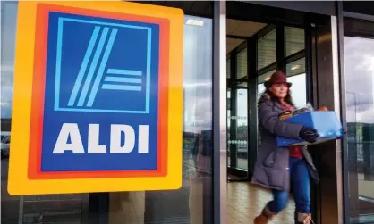  ?? Photograph: Richard Wayman/Alamy ?? A woman with a box of shopping leaves an Aldi store in Letterkenn­y, County Donegal, Ireland.