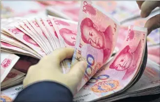  ?? AP PHOTO ?? In this 2016 file photo, a clerk counts Chinese currency notes at a bank outlet in Huaibei in central China’s Anhui province.