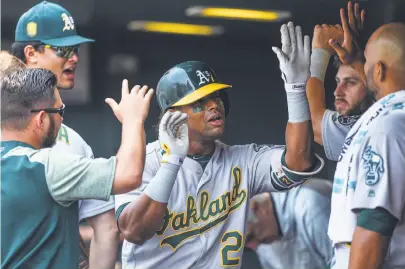  ?? Dustin Bradford / Getty Images ?? Khris Davis added to his home run total with one Sunday. Power is one reason the A’s are in the playoff hunt.