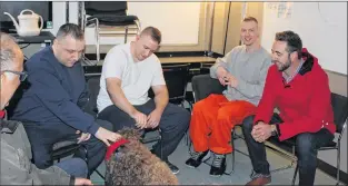  ?? ROSIE MULLALEY/THE TELEGRAM ?? Inmates Steven Rumsey, Brandon Phillips and Leonard Barr sit with Rick Gagnon (left) of St. John Ambulance and Andrew Parsons (right), minister of Justice and Public Safety and Attorney General, during the St. John Ambulance’s dog therapy program at...