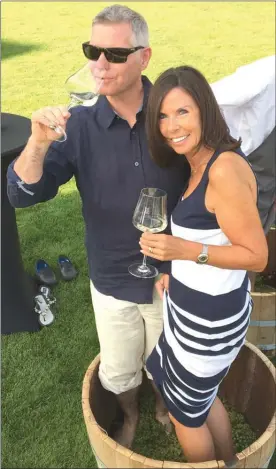  ?? Contribute­d photo ?? Fill ‘er Up columnist Steve MacNaull and his wife, Kerry, stomp a few riesling grapes before sitting down to Mission Hill Winery’s final long-table dinner of the season.