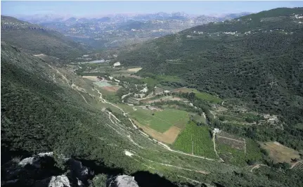  ?? Photos Joseph Eid / AFP ?? Lebanon’s Bisri Valley, south of Beirut, above, where a dam is planned to tackle chronic water shortages. The site is on a seismic fault line, which raised fears among residents. The 13th-century church of Mar Moussa in the Bisri Valley, below.